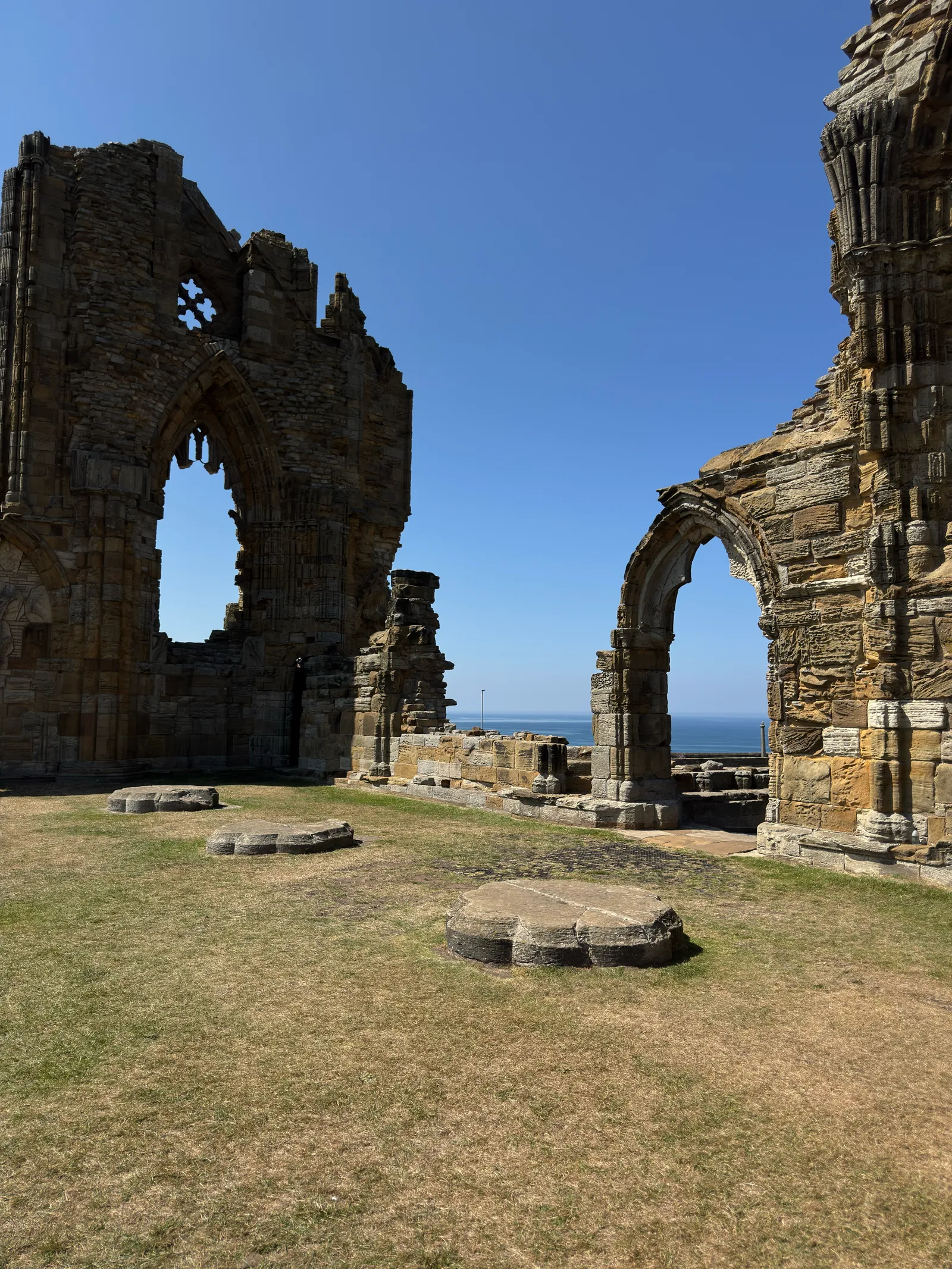 The old stone ruins of Whitby Abbey overlooking the sea.