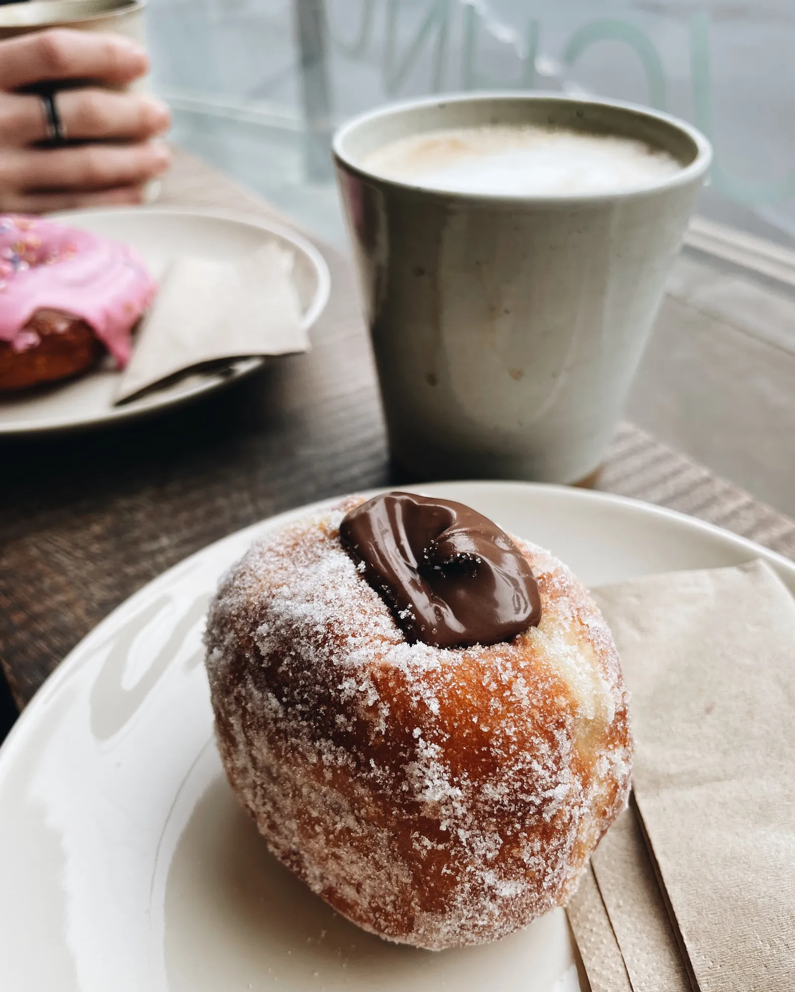doughnuts and coffee on a window counter