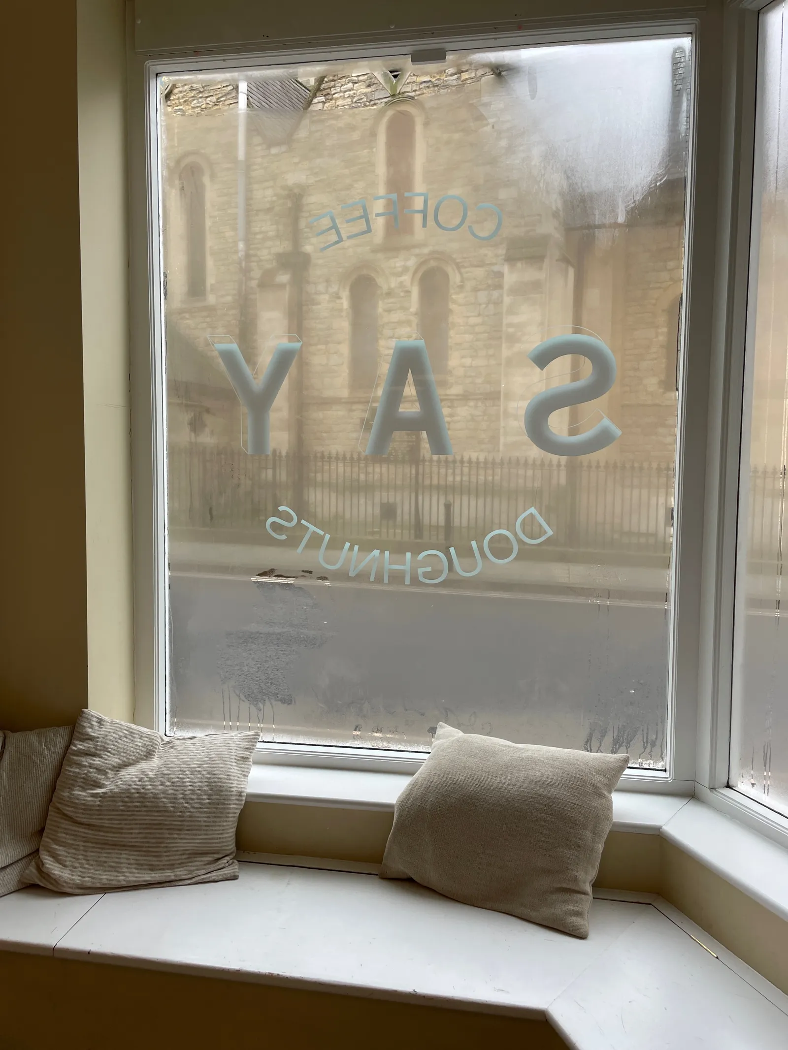 An interior shot of a window looking out toward the street