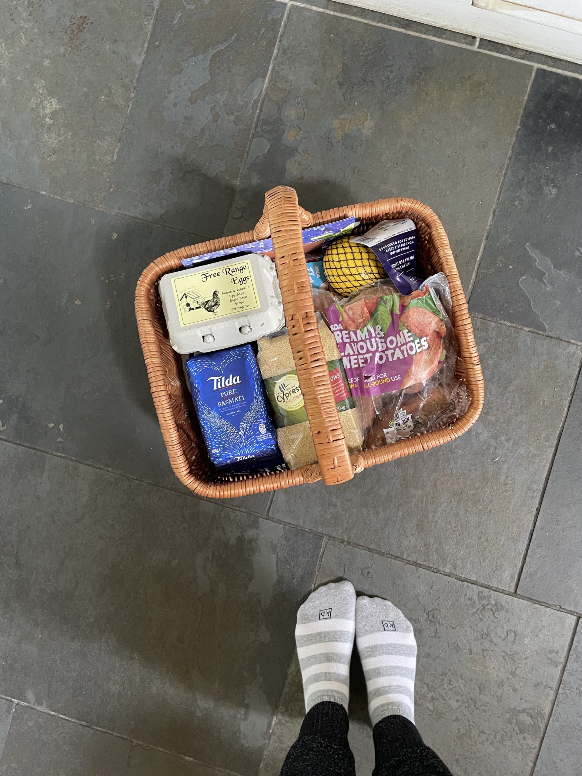 A basket full of food ordered from the nearby shops and dropped off by the cabin coordinators